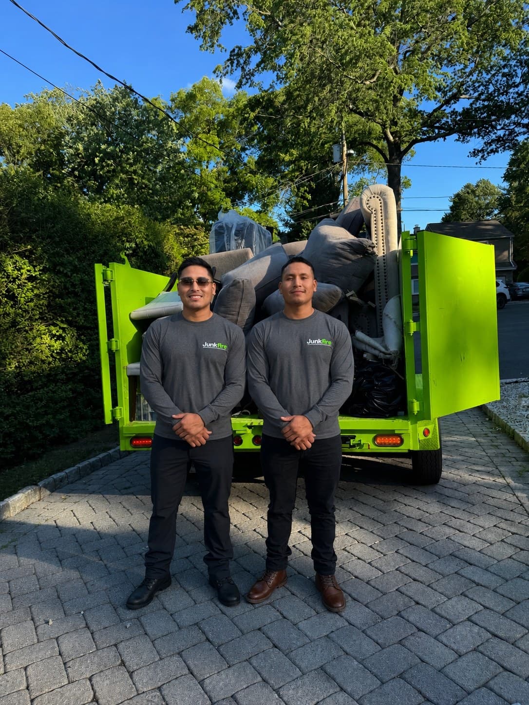 Junkfire team with green junk removal trailer